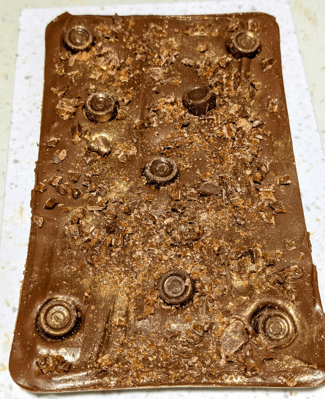 Giant, milk chocolate bar filled with salted caramel and topped with rolos and daim